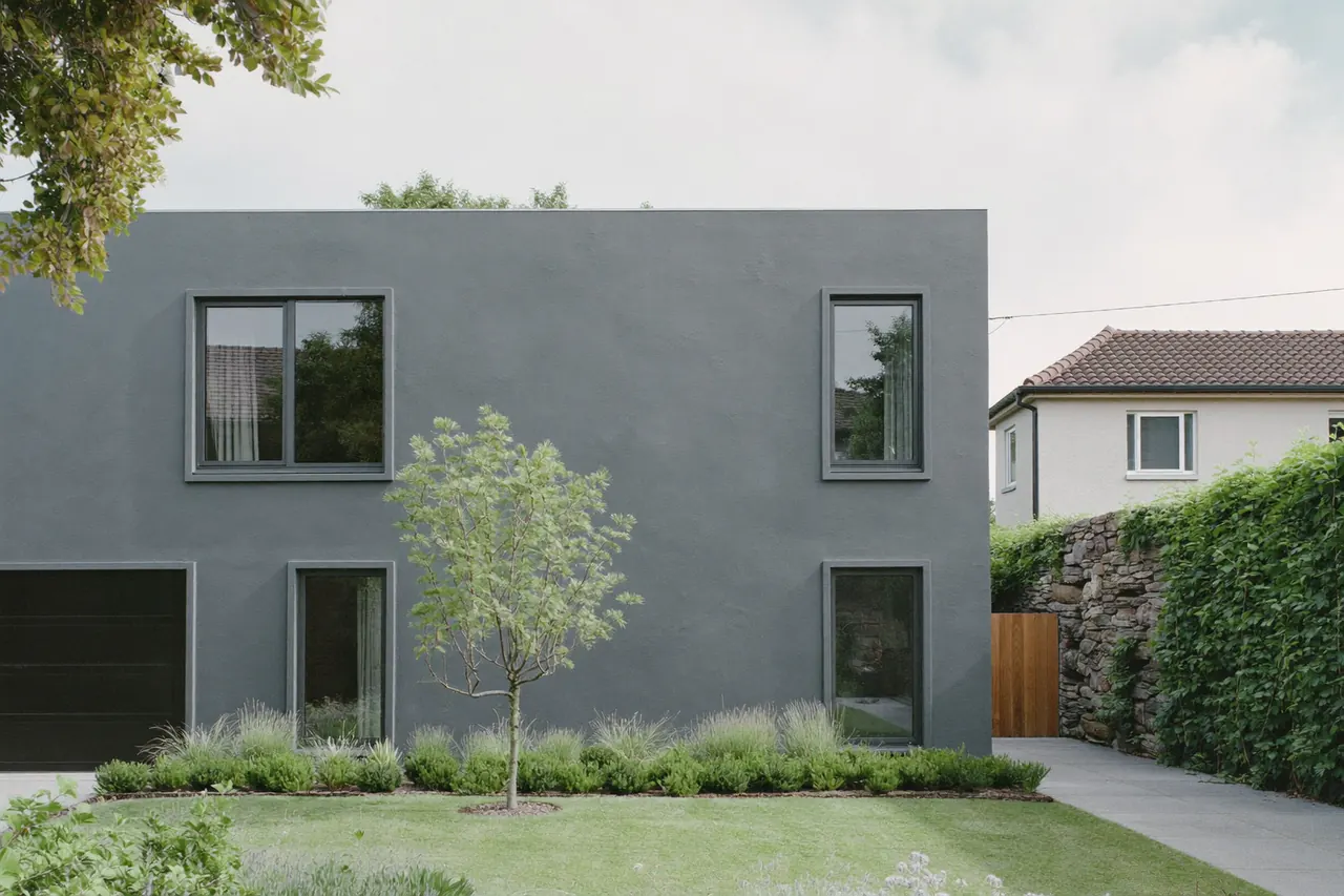 Grey casement windows on a rendered semi-detached house