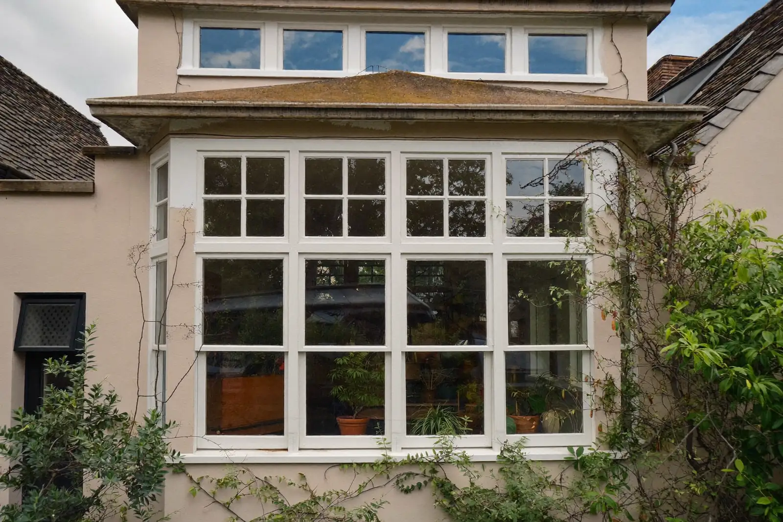 White casement windows across a UK cottage frontage